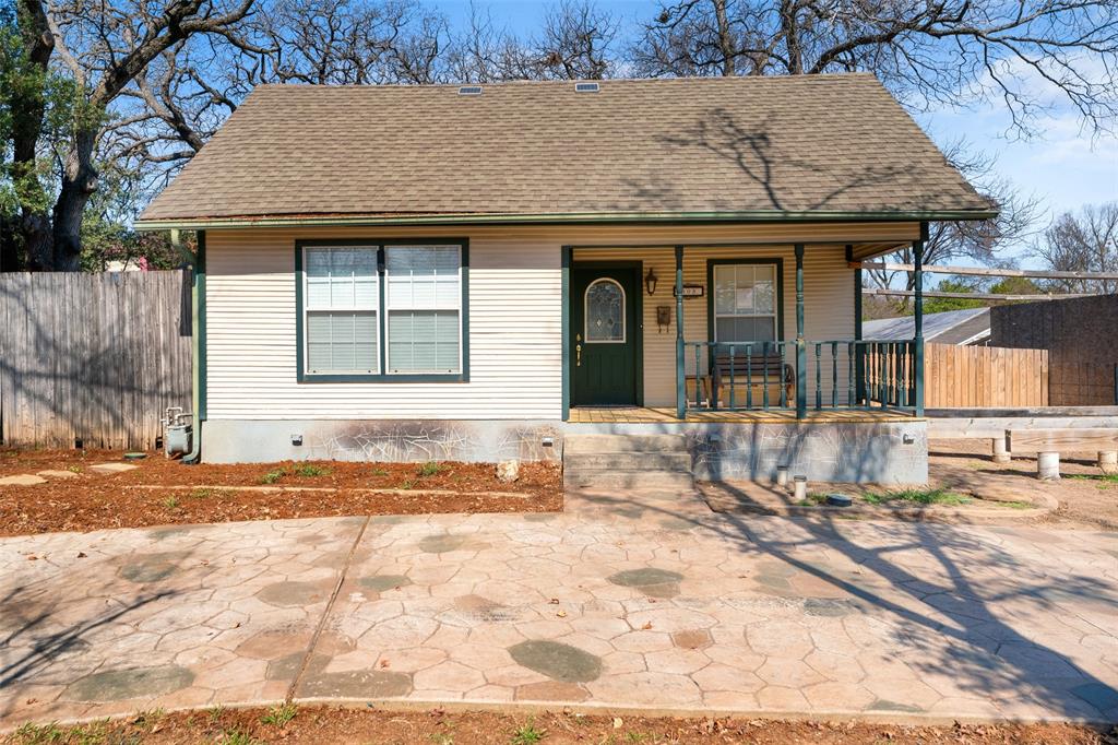 805 East Shady Grove Road Irving, TX 75060 - Photo 3 of 36 View of front of house with a shingled roof, a porch, and crawl space