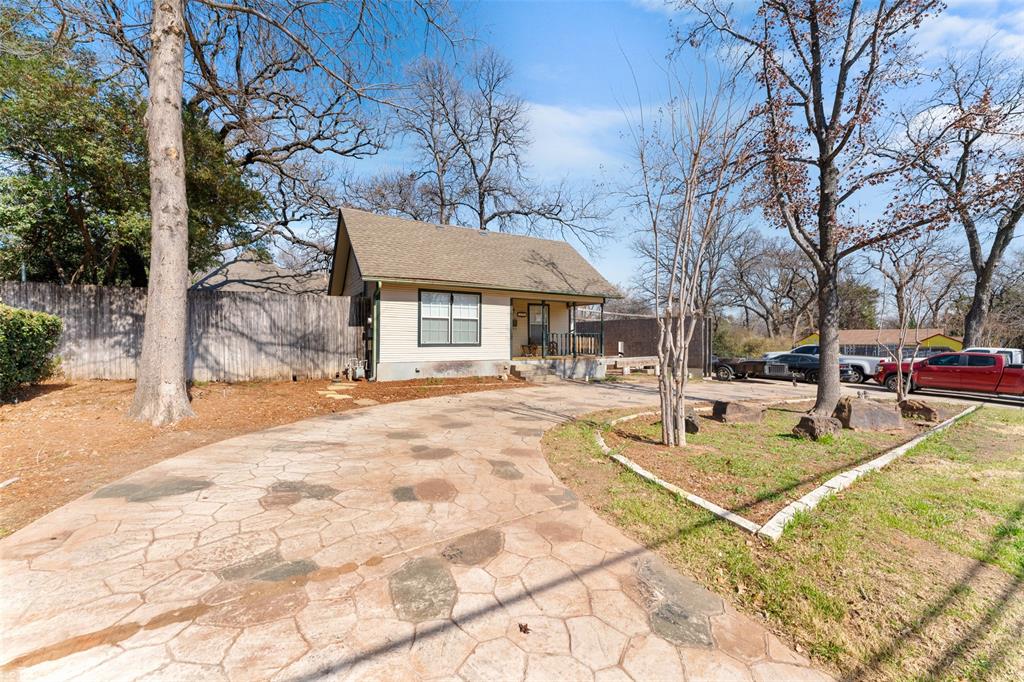 805 East Shady Grove Road Irving, TX 75060 - Photo 4 of 36 Bungalow-style house with a porch, driveway, and a shingled roof