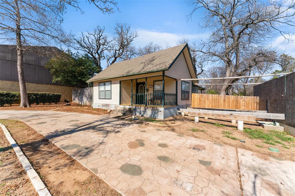 805 East Shady Grove Road Irving, TX 75060 - Photo 5 of 36 Bungalow-style house with covered porch, concrete driveway, and roof with shingles
