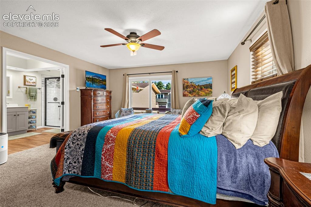 1658 Deer Creek Road Monument, CO 80132 - Photo 13 of 21 Bedroom has sliding glass doors to private balcony offering light as well as fresh mountain breezes in the summer!