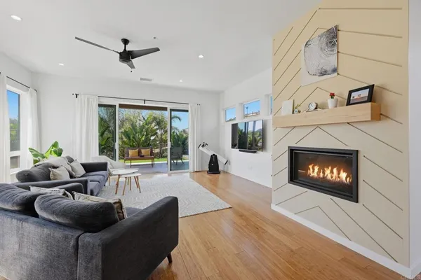 a living room with furniture and view of kitchen