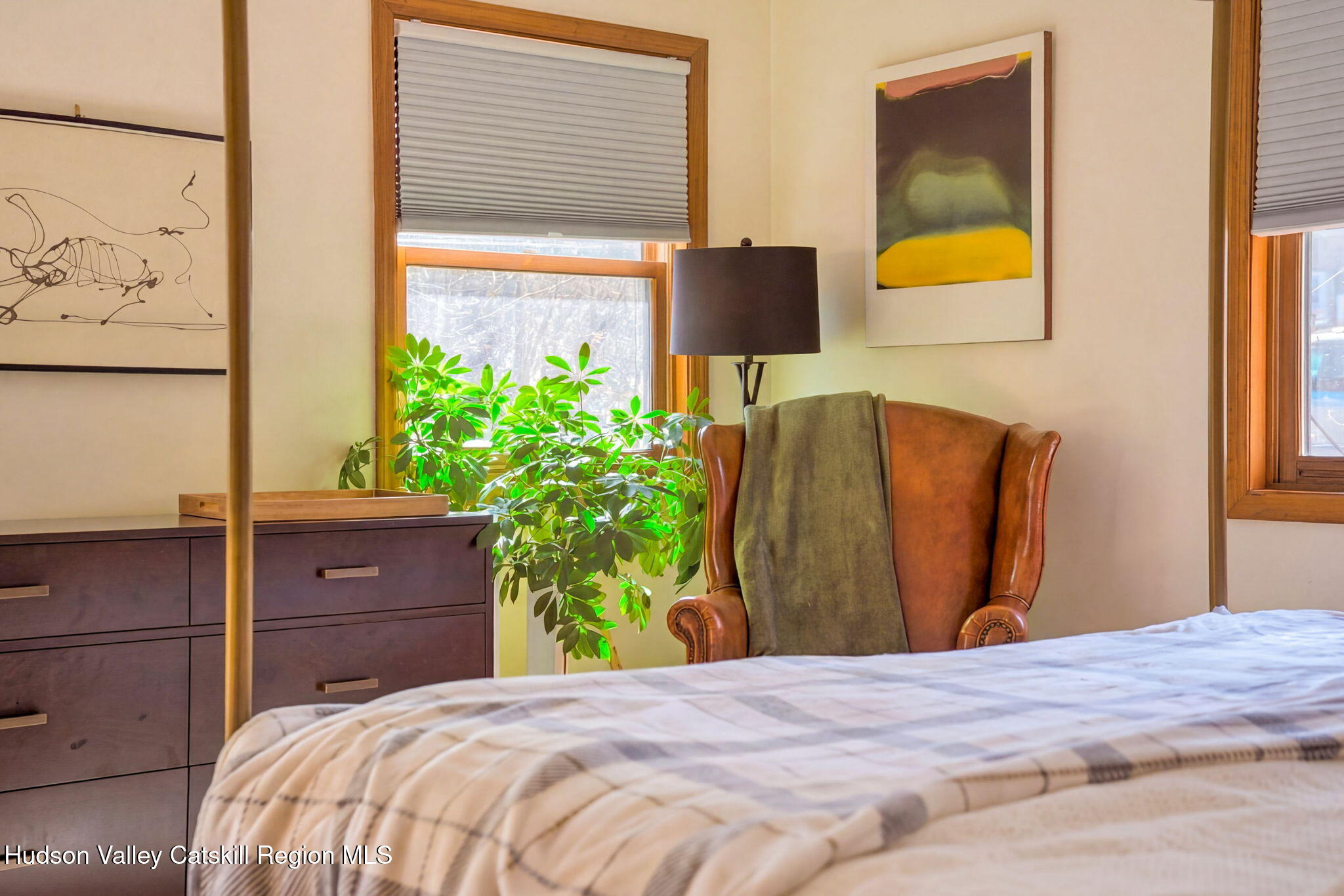 251 Sleepy Hollow Road Athens, NY 12015 - Photo 30 of 60 a bedroom with a bed and a potted plant