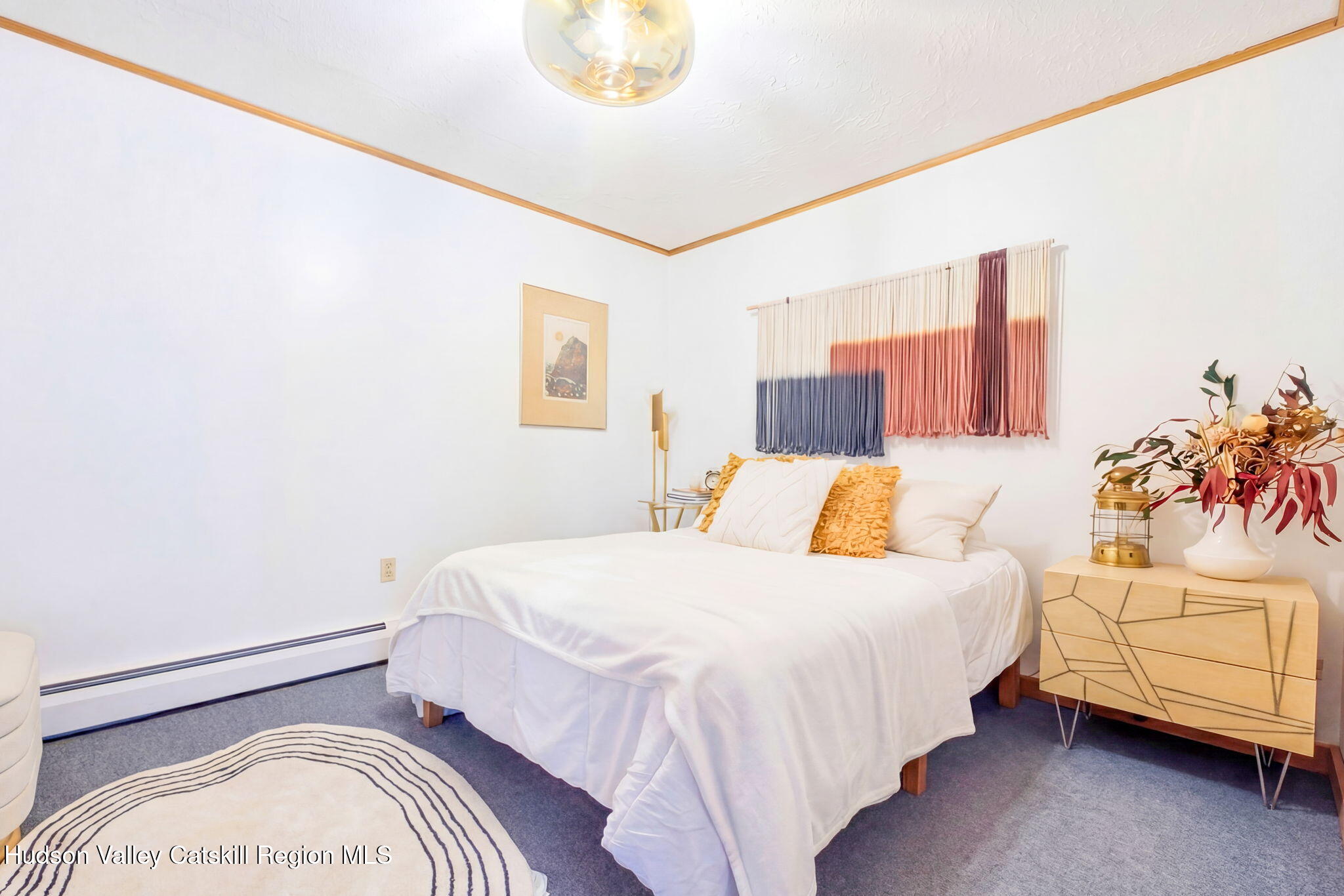 251 Sleepy Hollow Road Athens, NY 12015 - Photo 43 of 60 a bedroom with a bed and a potted plant