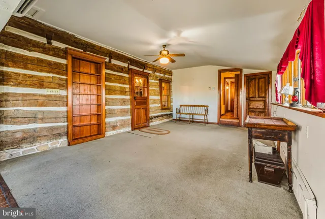 a bedroom with a bed and a flat tv screen on dresser