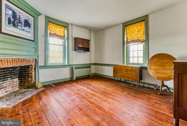a living room with couch chairs and a window