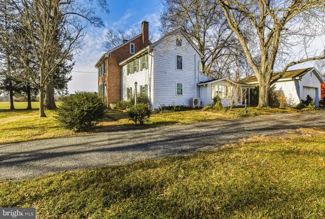 an empty room with windows and fireplace