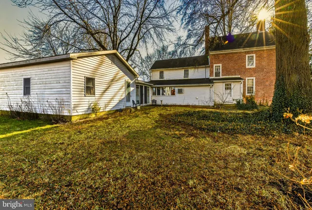 a view of a kitchen with stainless steel appliances granite countertop a sink and cabinets