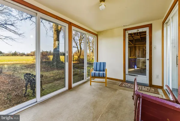 a view of a bedroom with furniture and windows