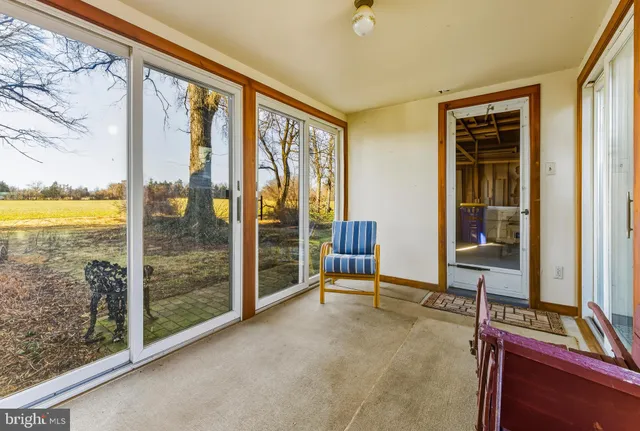 a view of a bedroom with furniture and windows