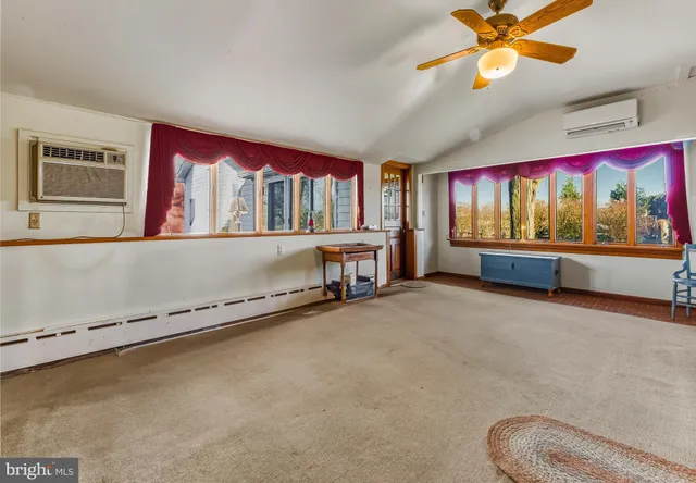 a living room with a bed and a fireplace