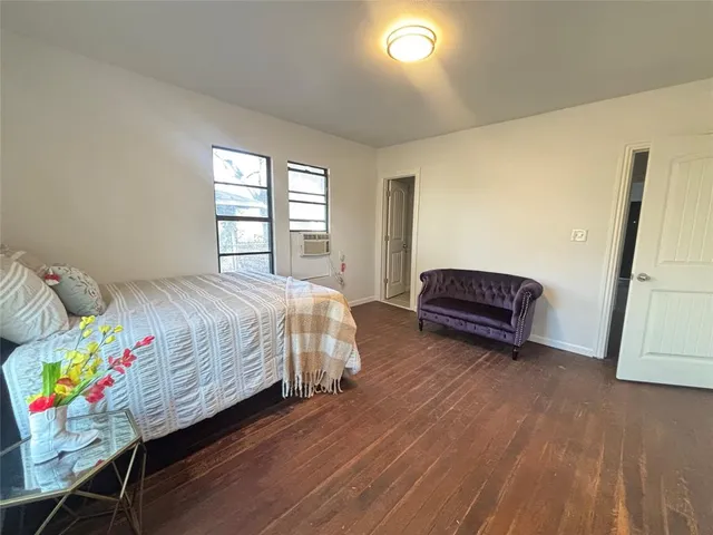 a spacious bedroom with a bed closet and a window