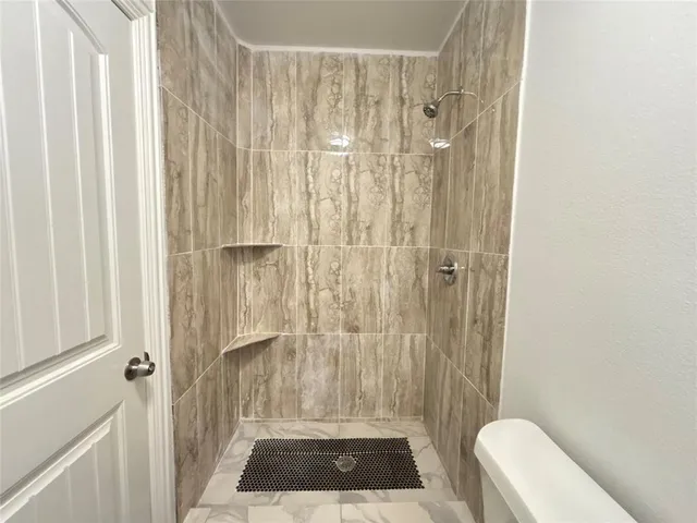 a bathroom with a shower curtain and a toilet