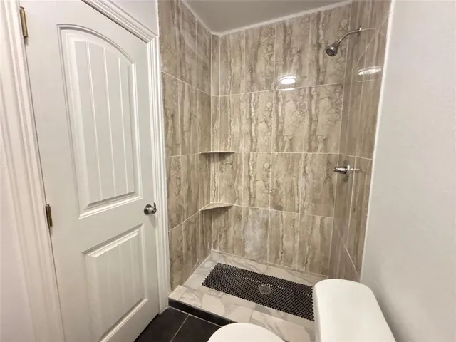 a bathroom with a shower curtain and a toilet