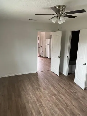 a view of an empty room and wooden floor