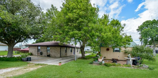 a view of a house with a yard and sitting area