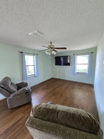 a view of a kitchen and dining room with wooden floor