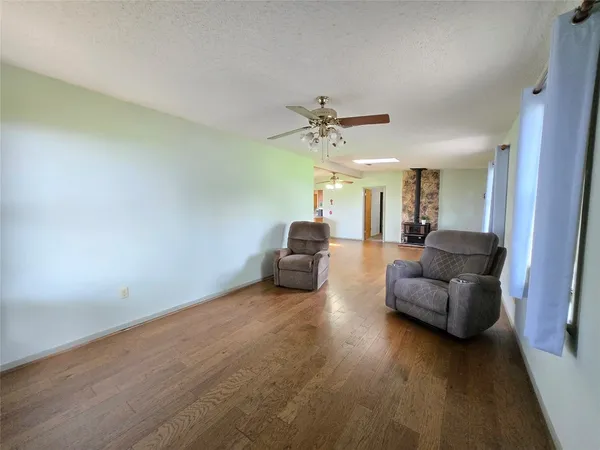 a view of a room with wooden floor and furniture
