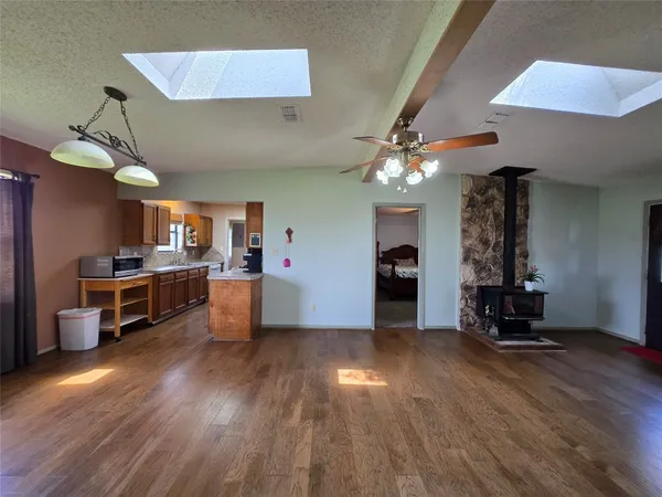 a large kitchen with kitchen island a sink stainless steel appliances and cabinets
