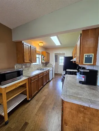 a stove top oven sitting inside of a kitchen