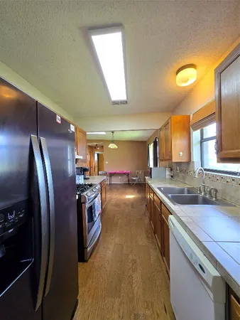 a bedroom with bed and wooden floor
