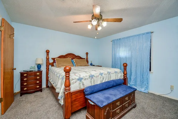 a bedroom with a bed and a dresser