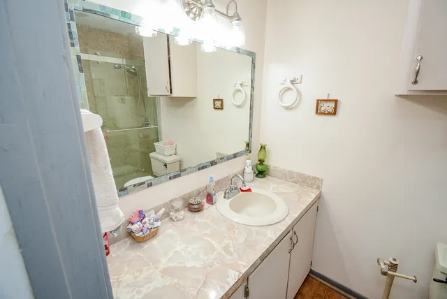 a bathroom with a toilet sink and mirror