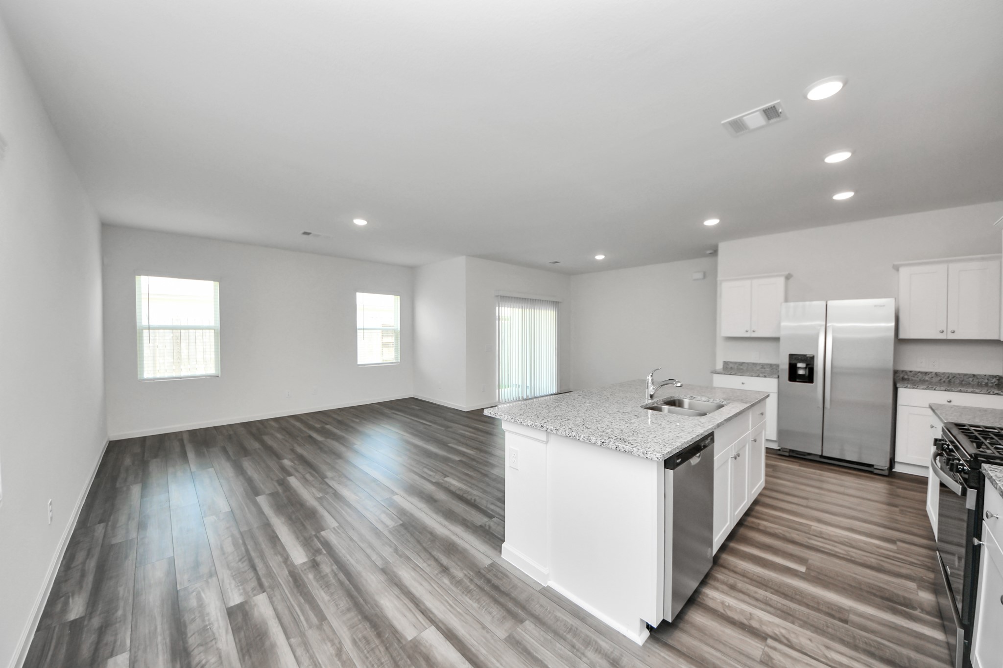 10315 Malta Trce Drive, Unit B Rosharon, TX 77583 - Photo 11 of 49 a kitchen with a stove a sink and a refrigerator