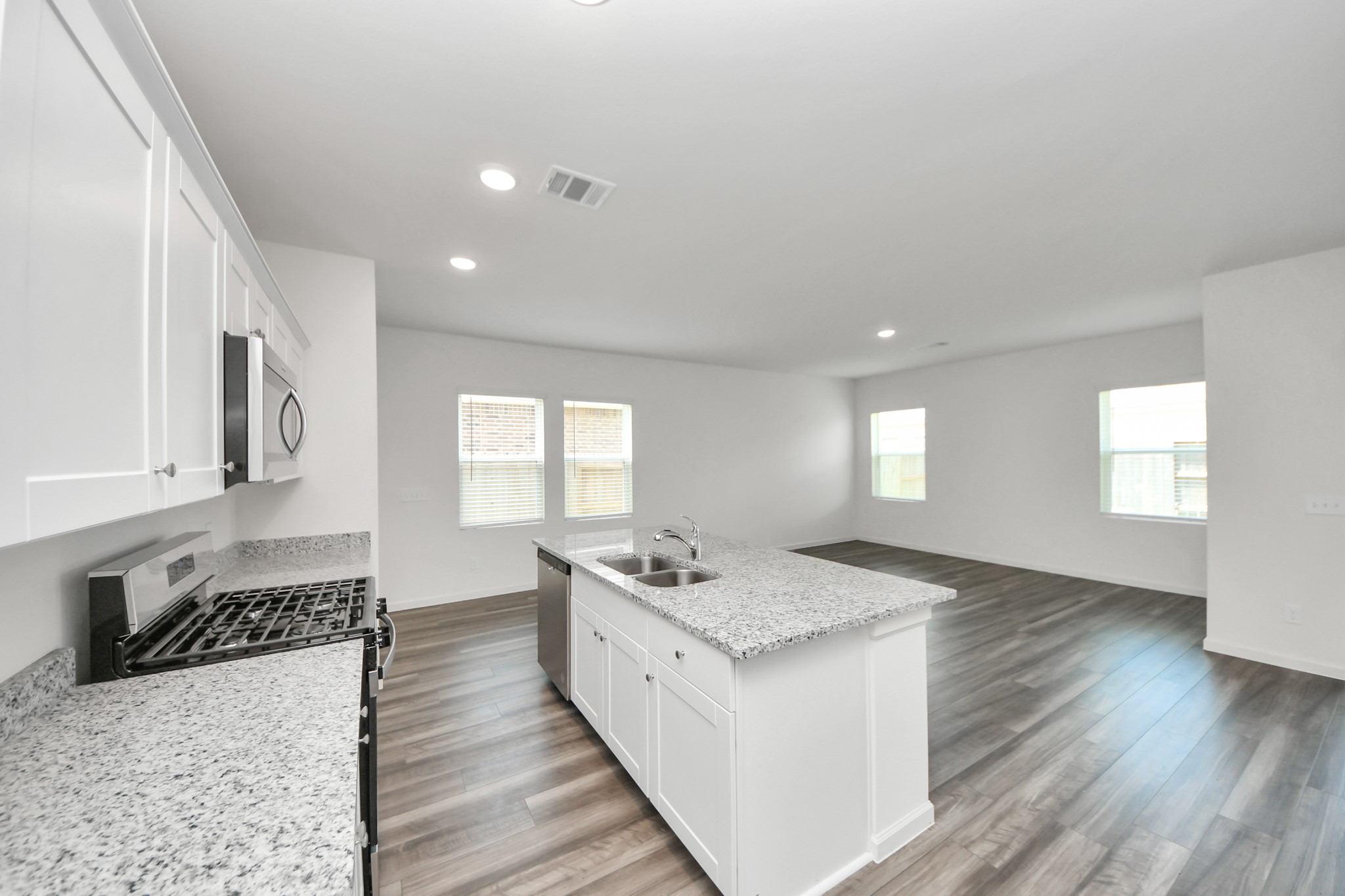 10315 Malta Trce Drive, Unit B Rosharon, TX 77583 - Photo 13 of 49 a kitchen with a sink stove and cabinets