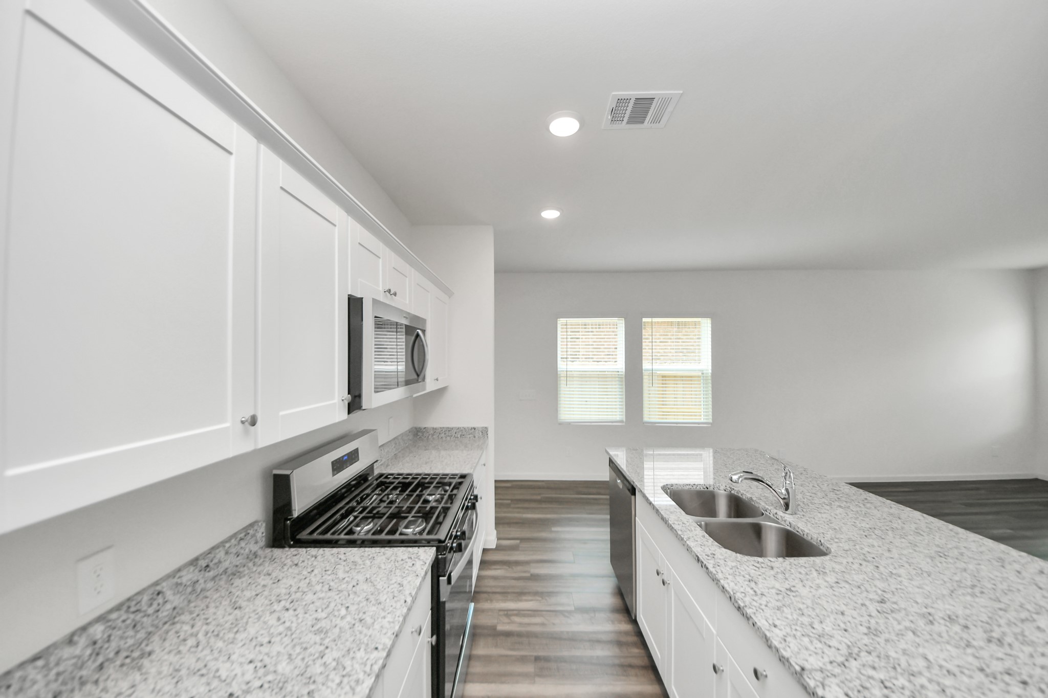 10315 Malta Trce Drive, Unit B Rosharon, TX 77583 - Photo 14 of 49 a kitchen with a stove a sink and a microwave