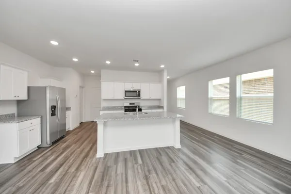 a living room with stainless steel appliances kitchen island wooden floor and view living room