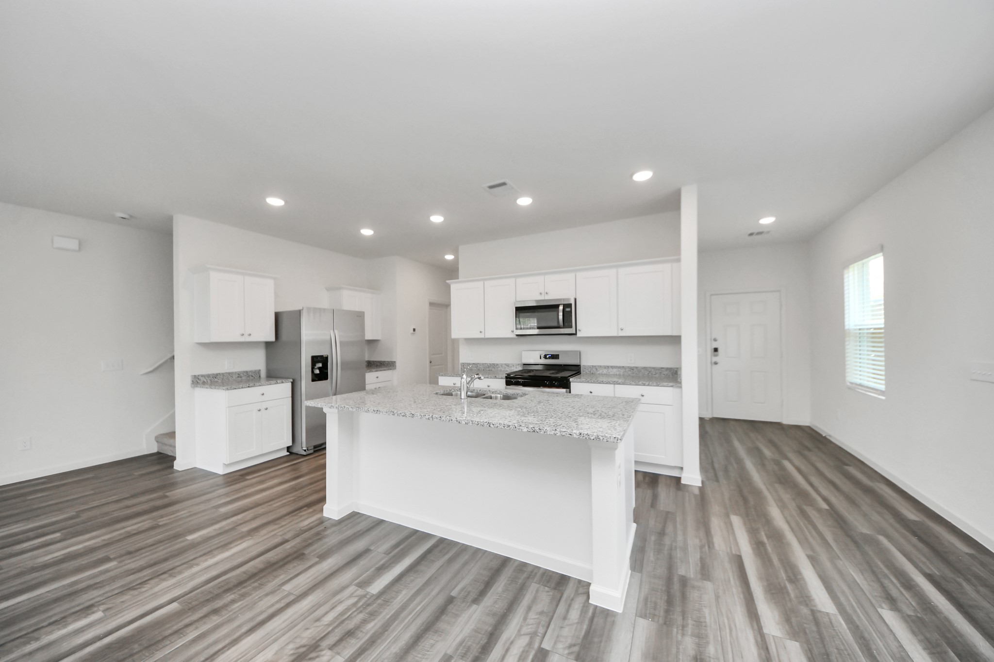 10315 Malta Trce Drive, Unit B Rosharon, TX 77583 - Photo 16 of 49 a kitchen with white cabinets and stainless steel appliances