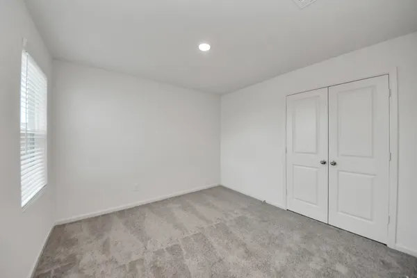 a view of an empty room and a window