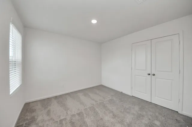 a view of an empty room and a window