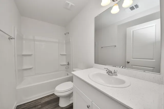 a bathroom with a sink toilet tub and shower