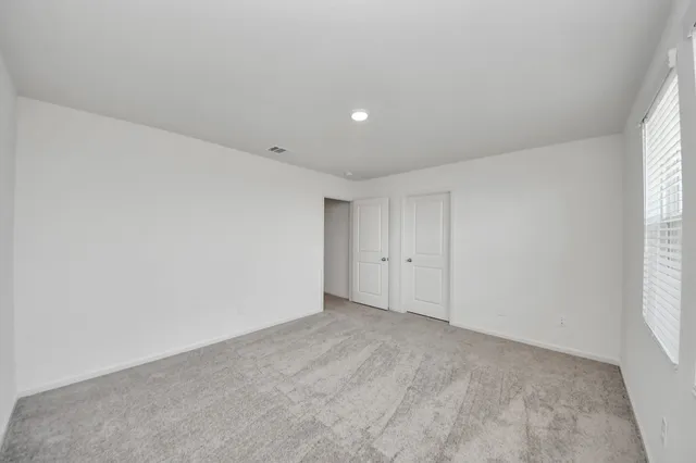 a spacious bathroom with a shower a sink and a mirror