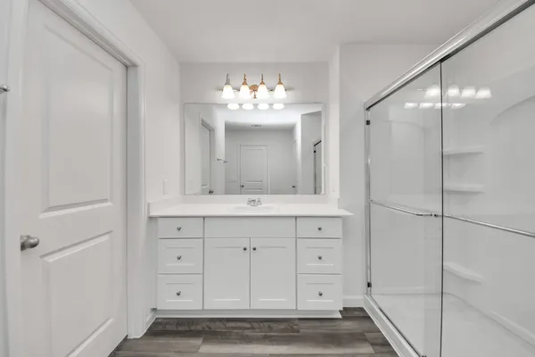 a bathroom with a toilet a sink and mirror