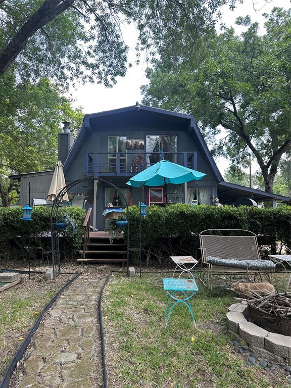 355 Spring Valley Street Gun Barrel City, TX 75156 - Photo 27 of 27 A-frame style residence featuring a second-story balcony with sliding glass doors and a dark-toned exterior