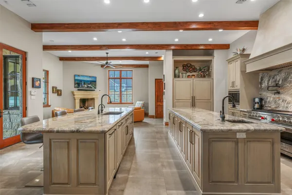 a en suite bathroom with a granite countertop sink and a large mirror