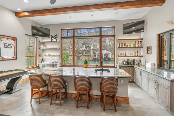a dining hall with stainless steel appliances a sink and a large window