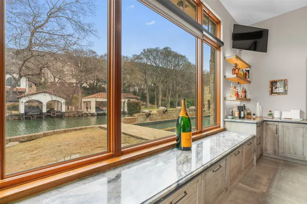 a view of a balcony with floor to ceiling windows with wooden floor