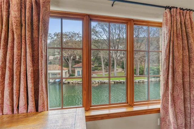 a view of a room that has a large window and front door