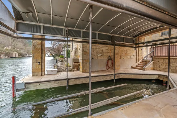 a view of a balcony with a tub and wooden walls
