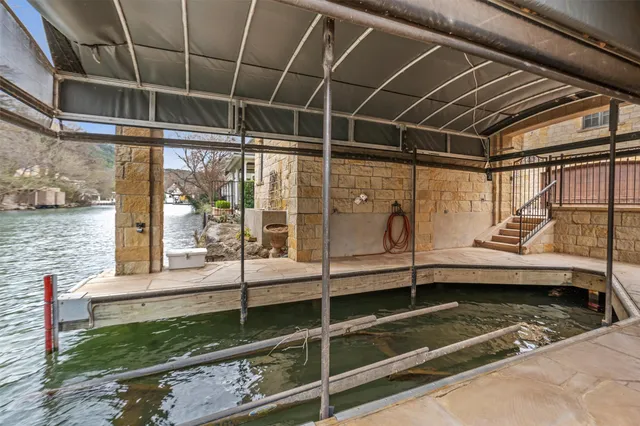 a view of a balcony with a tub and wooden walls