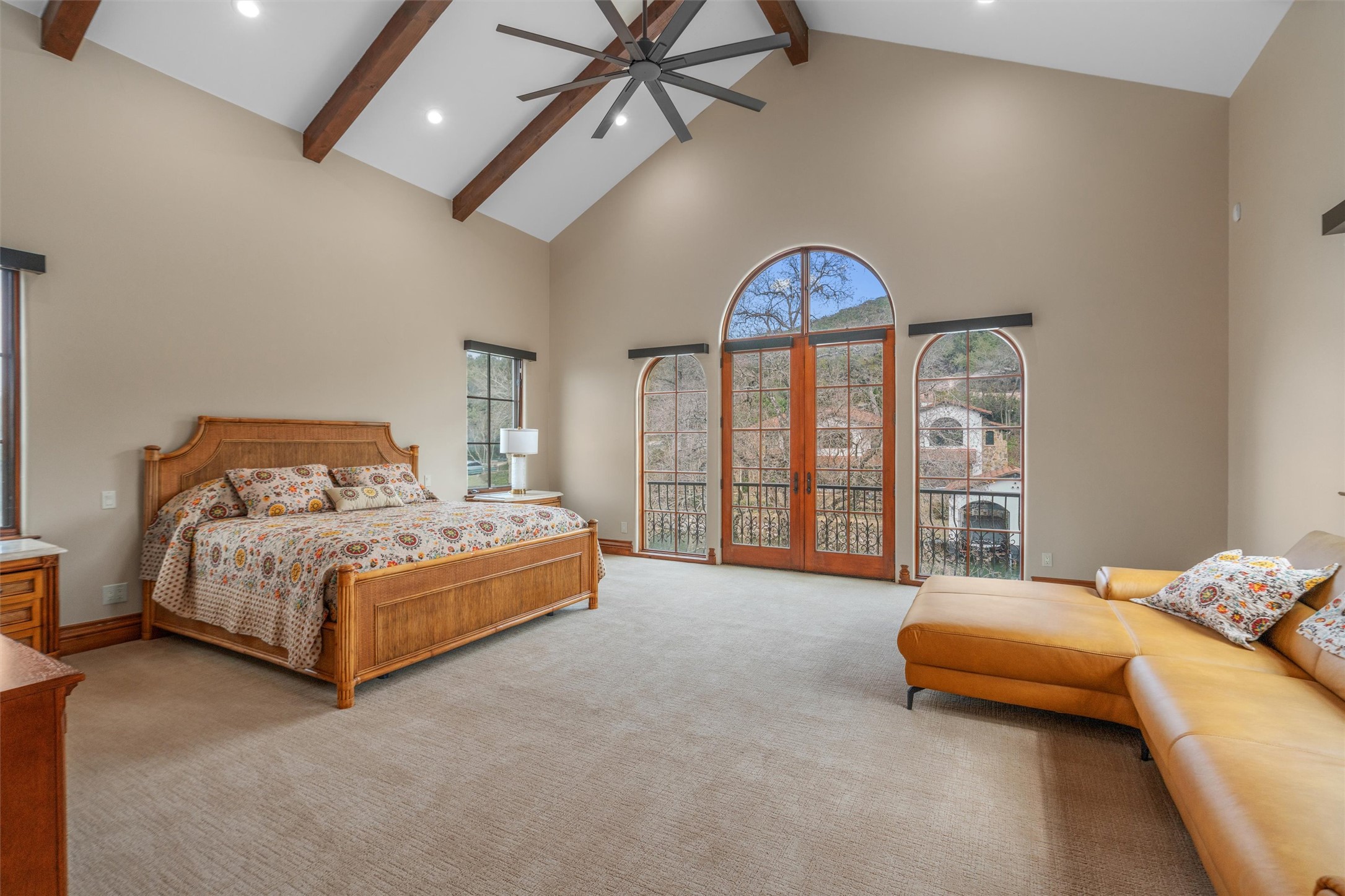 4407 Island Cove Austin, TX 78731 - Photo 30 of 40 a spacious bedroom with a bed and a chandelier