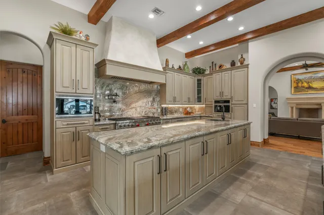 a kitchen with stainless steel appliances granite countertop a sink and cabinets