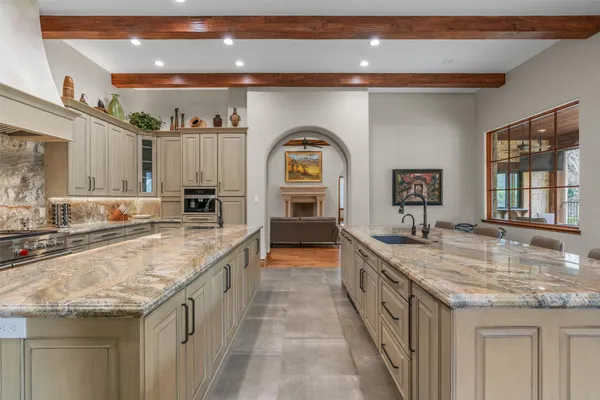 a bathroom with a granite countertop double vanity and a sink