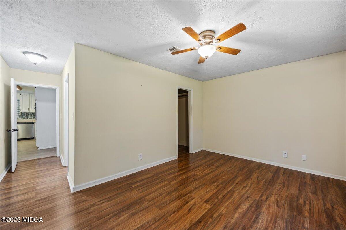 143 Ragan Drive Gray, GA 31032 - Photo 12 of 19 an empty room with wooden floor and a ceiling fan
