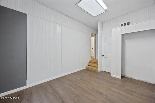 an empty room with wooden floor