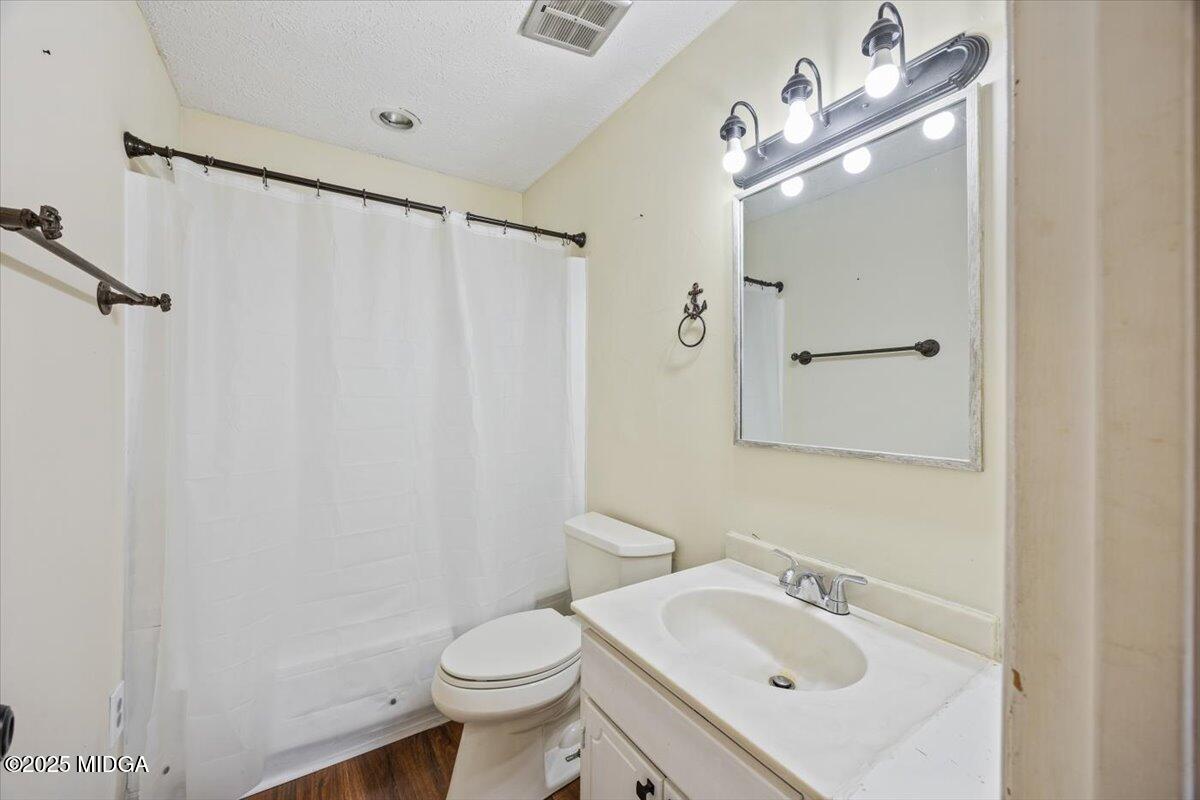 143 Ragan Drive Gray, GA 31032 - Photo 17 of 19 a bathroom with a sink vanity mirror and toilet