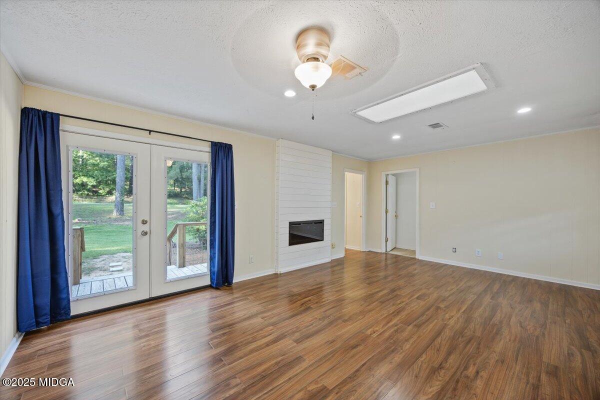 143 Ragan Drive Gray, GA 31032 - Photo 8 of 19 a view of an empty room with a window and wooden floor